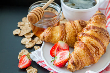 Breakfast - cereal and berries in white bowl, croissant