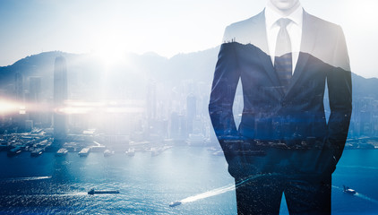 Multi exposure of young business man in the modern city on background