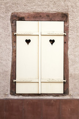 White wooden window with heart symbols