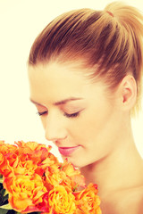 Fototapeta premium Smiling woman with fresh roses.