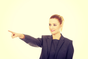 Businesswoman pointing away.