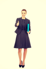 Businesswoman holding a binder.