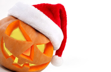 Halloween pumpkin shiny inside wearing christmas hat on white ba