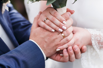 Bride and groom holding hands outdoors