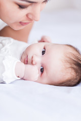 Young happy beautiful mother with her little baby