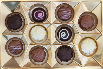 Box of assorted white, milk and dark chocolates, pralines and truffles
