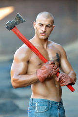 athletic young man holding ax