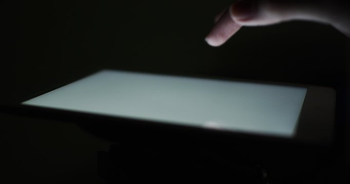 Closeup finger touching tablet computer touchscreen