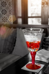 Red Glass Of Water On The Table With Sun Light : Selective Focus