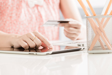 Woman shopping using tablet pc and credit card