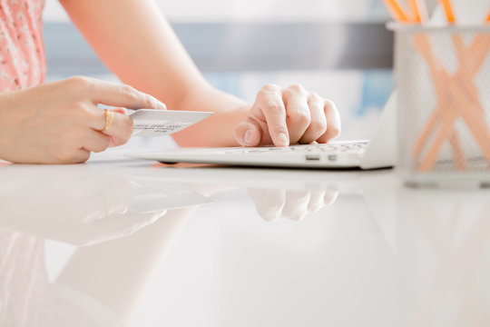 Woman Hands holding credit card and using laptop. Online shoppin