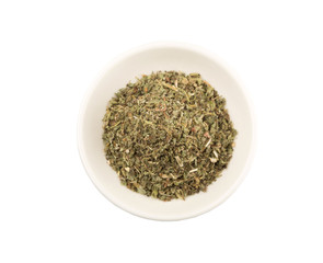 Dried lemon balm in white bowl over white background