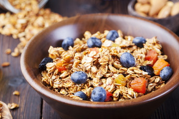 Healthy breakfast. Fresh granola, muesli with berries, honey and milk 