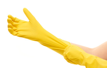 Close up of female hands putting on yellow protective rubber gloves against white background