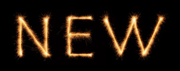 "NEW" lettering drawn with bengali sparkles isolated on black background