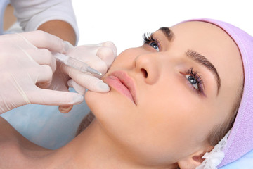 Beautiful woman gets an injection in her lips.