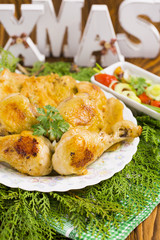 Christmas Roast Chicken with Red Hot Peppers, Olives, Onion, Parsley on Brown Wood Table with Christmas Twigs