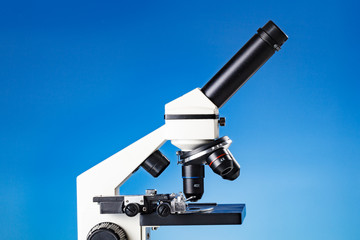 Fototapeta na wymiar Educational microscope on blue