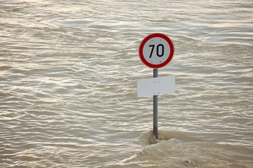 Flooded street with sign