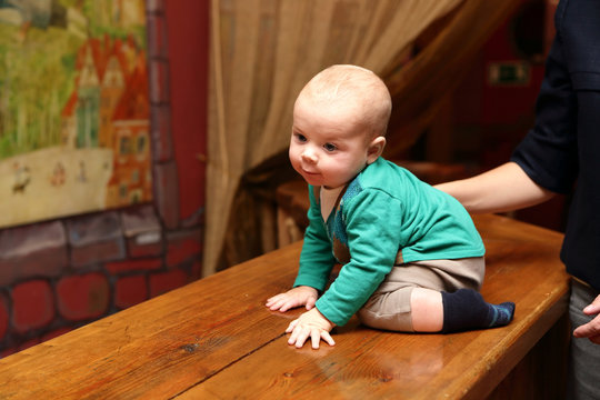 Baby boy sitting on the bar