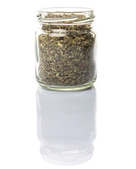 Dried lemon balm leaves in a mason jar over white background