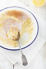 Lemon pudding cake with fresh lemons. Wooden background