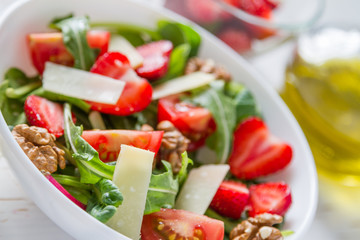 Strawberry salad in white bowl
