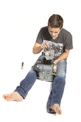 Teenage Boy Fixing An Engine