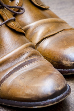 Brown leather shoes on a wooden floor 