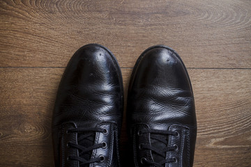 Brown leather shoes on a wooden floor 