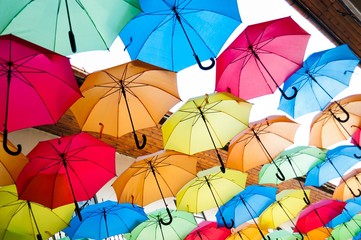Street decoration with colorful open umbrellas hanging over the alley. Kosice, Slovakia. Color background