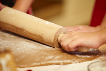 Working on unfinished dough with a rolling pin