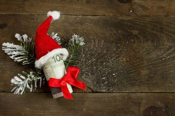 Gift money with red ribbon and Santa cap