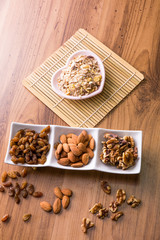 Mixed delicacies, walnut, currant, almond on wooden worktop