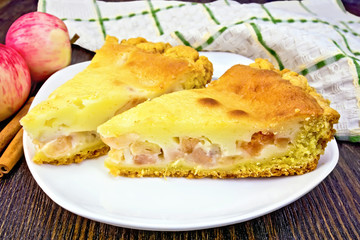 Pie apple with sour cream and cinnamon on dark board
