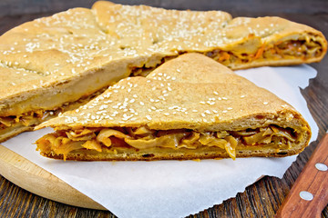 Pie with cabbage and sesame on board