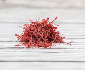 Dried saffron spices over wooden background