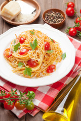 Spaghetti pasta with tomatoes and parsley