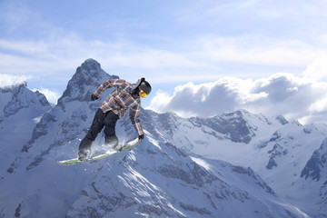Flying snowboarder on mountains