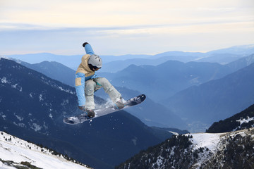 Flying snowboarder on mountains