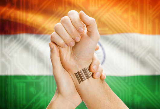 Barcode ID number on wrist and national flag on background - India