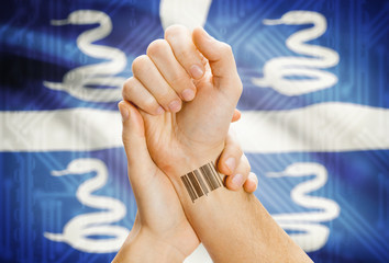 Barcode ID number on wrist and national flag on background - Martinique