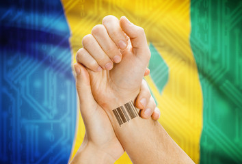 Barcode ID number on wrist and national flag on background - Saint Vincent and the Grenadines