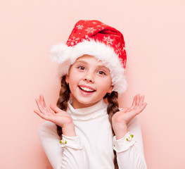 girl with pigtails in Santa Claus hat