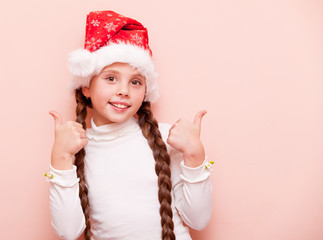 girl with pigtails in Santa Claus hat