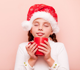 girl with cup in Santa Claus hat