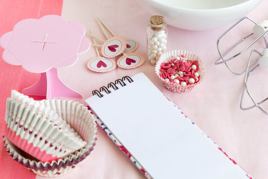 Cupcake cases with emtpy recipe notebook