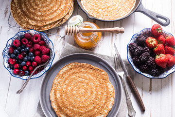 Traditional breakfast with pancakes and fruits