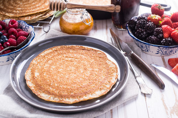 Traditional breakfast with pancakes and fruits