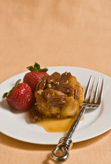 Praline French Toast with strawberries on white plate and fork